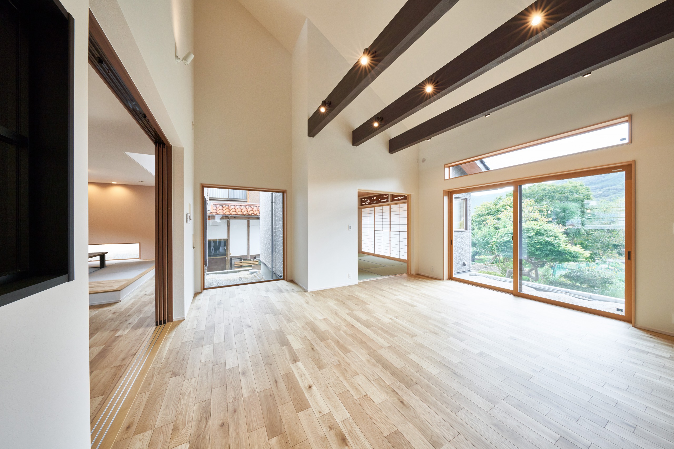 勾配天井や隣のキッチンとのつながりで縦にも横にも広々なリビング。